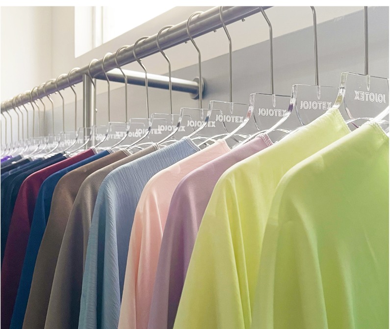 Pastel garments arranged on a rail